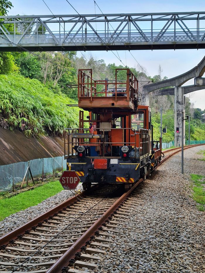 Maintenance trolley on railway tracks under footbridge in Malaysia